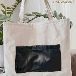 توت بگ متقال روشن با طرح چاپی قاصدک و جیب چرم از نمای پشت- لباس زنانه